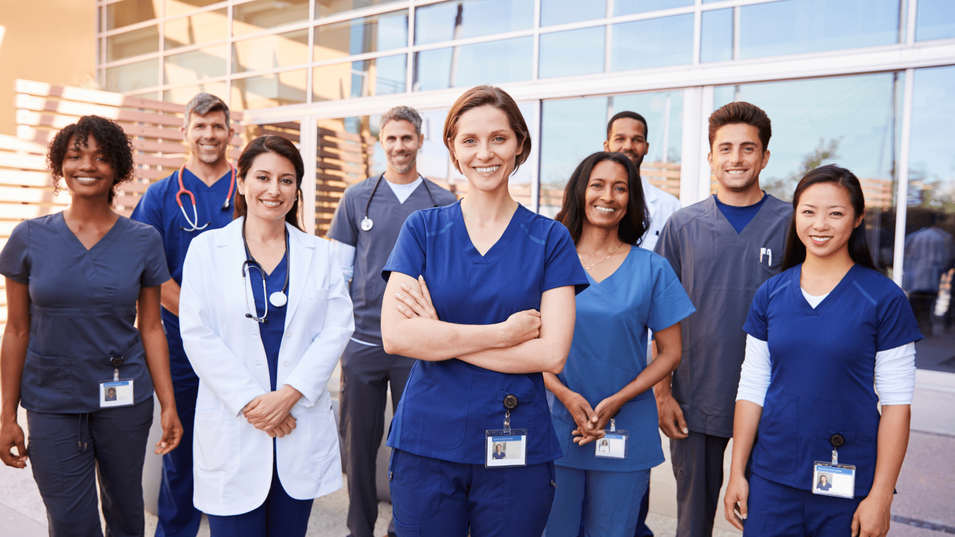 group of healthcare workers standing in blue scrubs