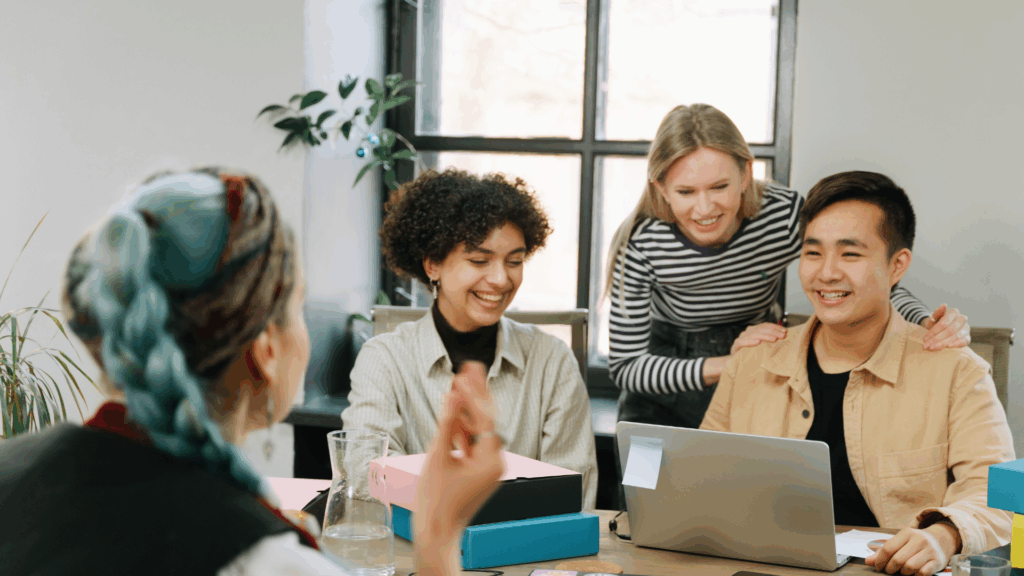 group of people looking at a laptop